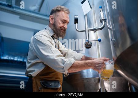 Brewery master quality tasting of craft beer at production facility Stock Photo