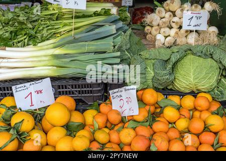 Tangerines, leek and cabbage for sale at a market Stock Photo