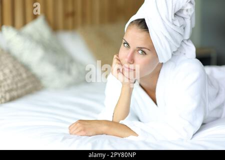 Beautiful woman after showering on a bed Stock Photo