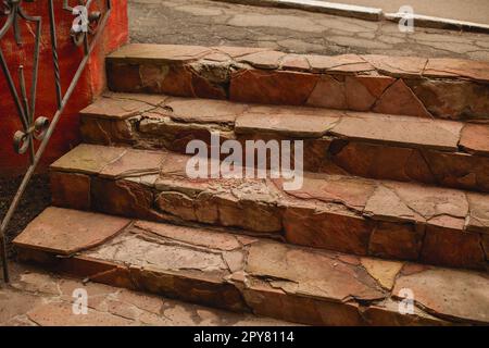 Outdoor broken tile stairs near the building. Destroyed steps. Ruins of crushed staircase Stock Photo