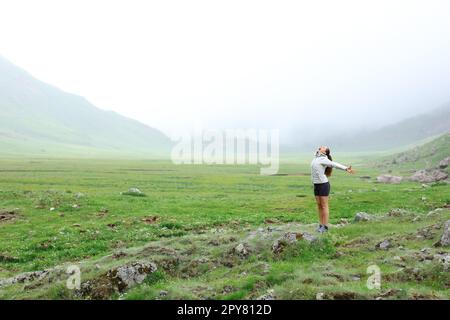 Happy hiker in the mountain celebrating Stock Photo