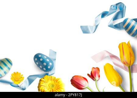 Easter decorations with eggs, flowers and blue ribbons Stock Photo