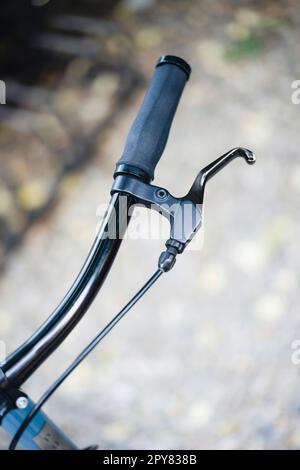 Black brake lever on the handlebar of a bicycle Stock Photo