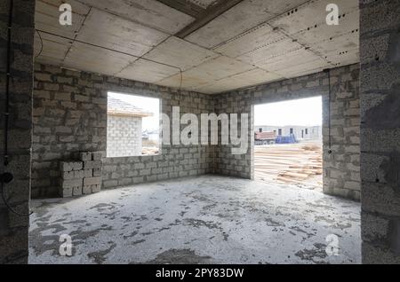 Construction of an individual residential building, view of a large spacious room with stained glass windows Stock Photo