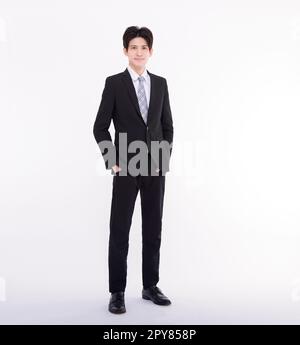 Full length portrait of  young businessman standing with his hands in the pockets. Stock Photo