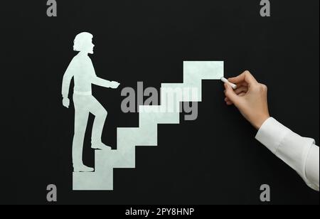 Woman drawing person going up stairs on chalkboard, closeup. Steps to success Stock Photo