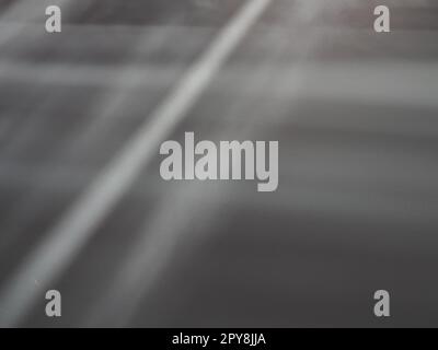 Illumination rays on gray surface. Abstract rays of light and lens flare on a gray background. Vertical, horizontal and diagonal light stripes Stock Photo