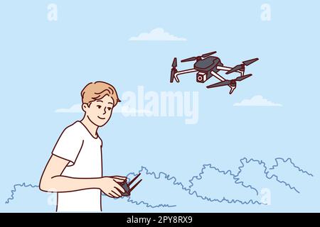 Teenage boy launches quadcopter using remote control and makes aerial photography from drone. Guy has hobby launching miniature aircraft or quadcopter Stock Photo
