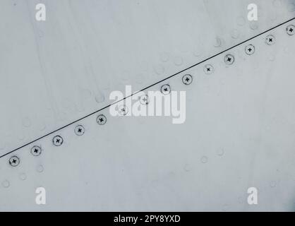 Silver metal surface with rivets Stock Photo - Alamy