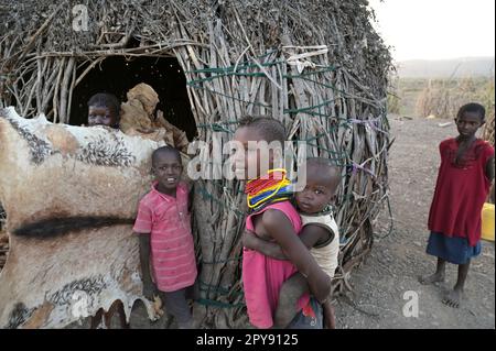 KENYA, Turkana, village Nariokotome, Turkana tribe, shepherd hamlet, children with goat fur, they are used as sleeping pad Stock Photo