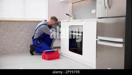 Plumber Cleaning Drain And Pipe Stock Photo