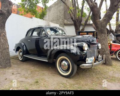 Old black 1940 Chevrolet Chevy Master 85 business coupe by GM in a park. Chromes. Grille. AAA 2022 classic car show. Stock Photo