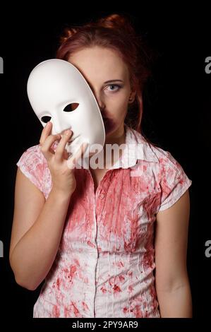 female zombie with halloween mask and bloody shirt Stock Photo