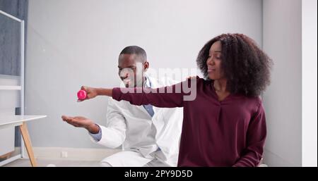 Physical Rehabilitation Therapist Helping Man Stock Photo