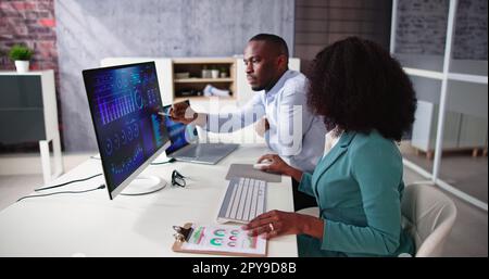 African American Analyst Using Financial Business Data Stock Photo