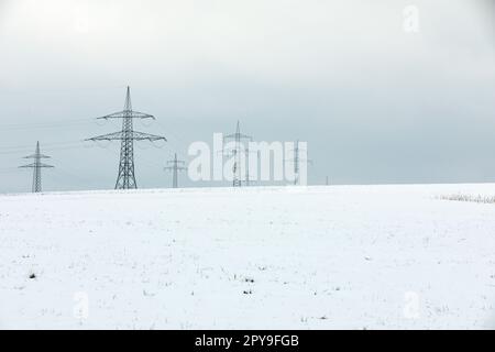 Electrical towers in winter landscape Stock Photo