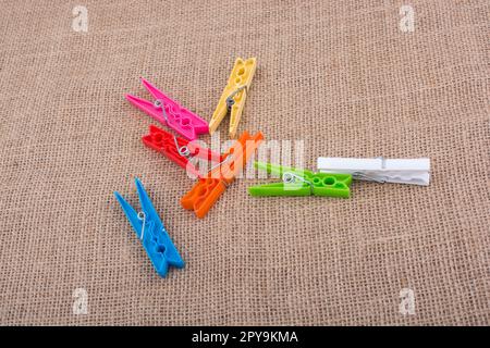 Clothespins placed on a linen canvas background Stock Photo