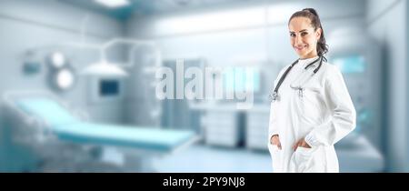 Smiling female doctor in a white coat with a stethoscope in the background of a defocused modern ambulance interior - Copy space. Stock Photo