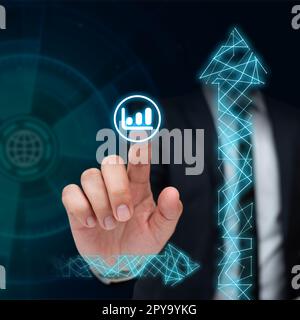 Man in black office suit sitting at the table and pressing virtual button with his finger. Futuristic digital design with colored glow. New technological infrormation. Stock Photo