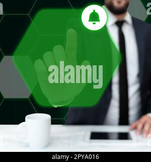 Man in black office suit sitting at the table and pressing virtual button with his finger. Futuristic digital design with colored glow. New technological infrormation. Stock Photo