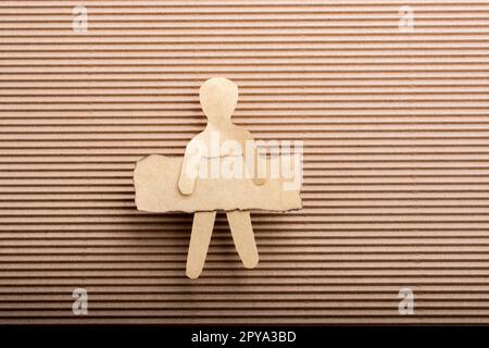 Paper man shape holding burnt note paper in hand Stock Photo
