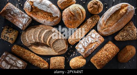 Assorted bakery products including loafs of bread and rolls Stock Photo