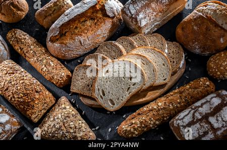 Assorted bakery products including loafs of bread and rolls Stock Photo