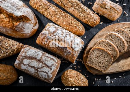 Assorted bakery products including loaves of bread and rolls Stock Photo