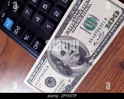 Money dollars and calculator on desktop Stock Photo