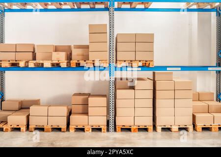 shelves with goods in cardboard boxes in the warehouse Stock Photo