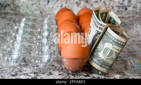 Brown eggs in plastic container with money Stock Photo