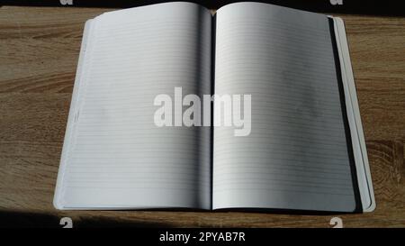U-turn notebook with blank white pages. Natural light Stock Photo