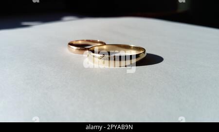 gold jewelry, two golden wedding rings on a white background Stock Photo