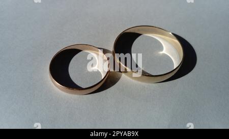 Two wedding gold rings. White background Stock Photo