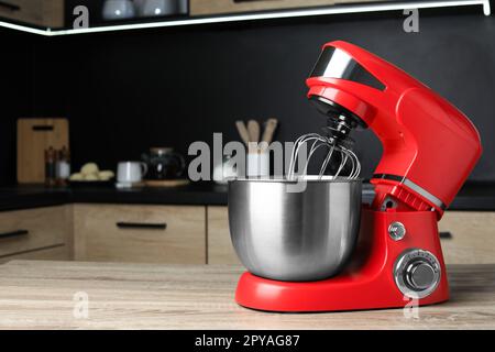 White kitchen machine and stand mixer on a wooden table in a bright design  apartment Stock Photo - Alamy