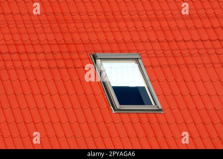 Modern Skylight Window on a Red Roof Stock Photo