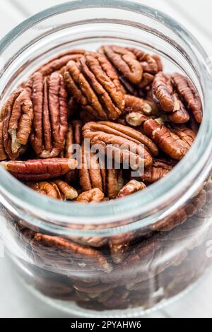 Peeled pecan nuts in jar. Stock Photo