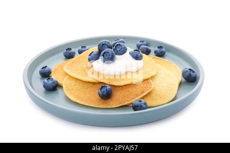 Tasty pancakes with natural yogurt and blueberries on white background Stock Photo