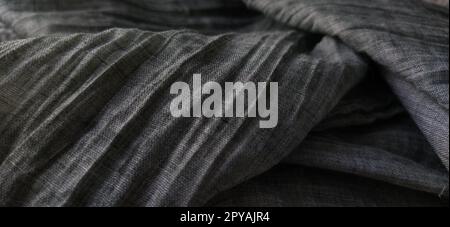 Gray pleated fabric or crumpled textile closeup. Light translucent curtains or tulle in the Scandinavian style. Soft focus Stock Photo