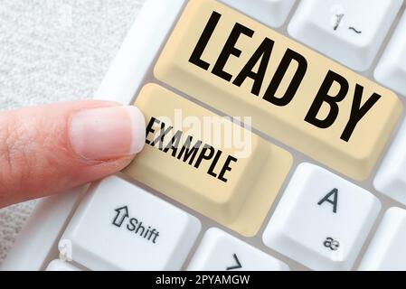 Text caption presenting Lead By Example. Business idea Be a mentor leader follow the rules give examples Coach Stock Photo