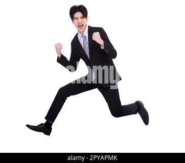 Excited business man running and jumping in the air with success gesture Stock Photo