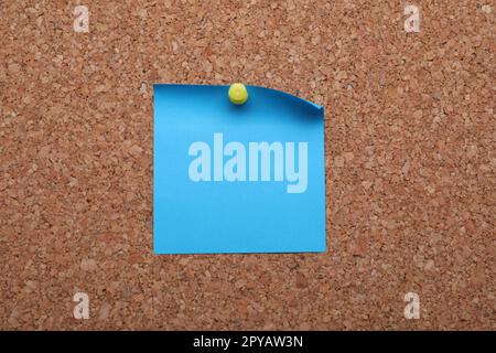 Blank paper note pinned to cork background, closeup Stock Photo