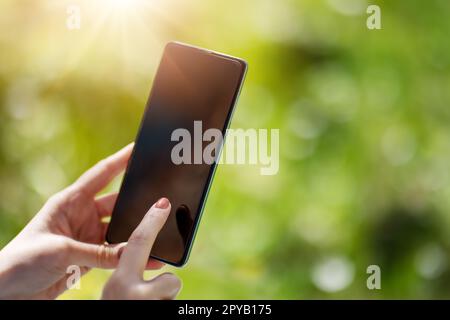 Closeup view of the woman's hands holding smartphone. Stock Photo