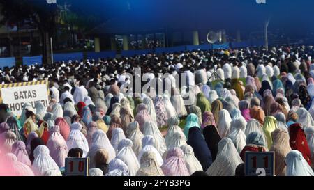 implementation of the Eid al-Fitr prayer performed by Indonesian Muslims in a field in Central Java. Stock Photo