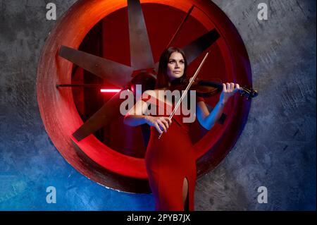 Violin player performing solo over loft interior background Stock Photo