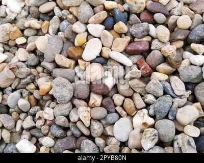Pebbles as a background image. White, gray, brown, reddish small stones or pebbles. Stock Photo