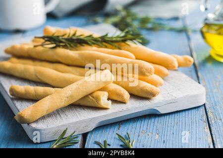 Italian grissini bread sticks on blue table. Stock Photo