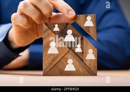 HR Recruitment Hand Making Tangram Puzzle Stock Photo