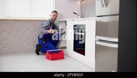 Plumber Cleaning Drain And Pipe Stock Photo