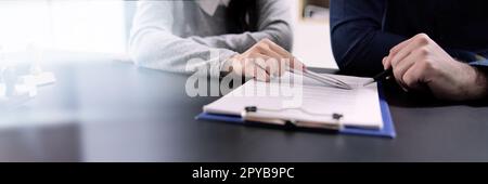 Two Businesspeople Hand Analyzing Document Over Glass Stock Photo